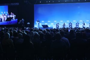 Large conference hall with speaker and panel onstage